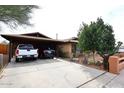 Charming brick home with covered parking, set in a desert landscape with mature trees at 2619 W Lamar Rd, Phoenix, AZ 85017