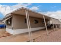A single-story home featuring a covered carport, exterior windows, and modern architecture at 2650 W Union Hills Dr # 350, Phoenix, AZ 85027