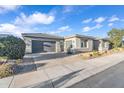 Contemporary home featuring a two-car garage, desert landscaping, and paved driveway at 2854 E Cashman Dr, Phoenix, AZ 85050