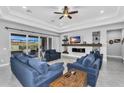 Spacious living room featuring a fireplace, ceiling fan, and access to an outdoor area at 2854 E Cashman Dr, Phoenix, AZ 85050