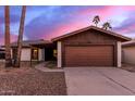 Single story home featuring a large driveway and attached two car garage at 3037 W Libby St, Phoenix, AZ 85053