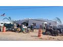 Home exterior with white stucco walls, a gated entrance, and a tile roof shows signs of renovation at 317 W Frontier St, Apache Junction, AZ 85120