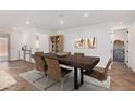 Contemporary dining room featuring a sleek wooden table and stylish decor for elegant entertaining at 33395 N 132Nd Dr, Peoria, AZ 85383