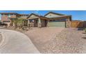 Charming home featuring stone accents, a two-car garage, and a brick paved driveway at 33395 N 132Nd Dr, Peoria, AZ 85383