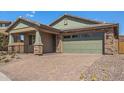 Charming home featuring stone accents, a two-car garage, and a brick paved driveway at 33395 N 132Nd Dr, Peoria, AZ 85383