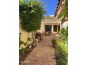 Charming outdoor patio area with brick pavers, lush greenery, and comfortable seating under a pergola at 50 W Calle De Arcos --, Tempe, AZ 85284