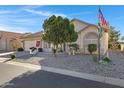 Single-story home with desert landscaping, a charming front entryway, and an attached two-car garage at 6520 S Pebble Beach Dr, Chandler, AZ 85249