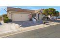 Traditional home with a tidy front yard, rock landscaping, and an attached two-car garage at 6520 S Pebble Beach Dr, Chandler, AZ 85249