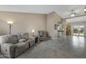 Neutral living room with tile flooring, a comfortable sofa, and bright natural light at 6520 S Pebble Beach Dr, Chandler, AZ 85249