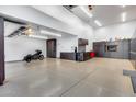 Expansive garage space with custom cabinets, work area, and ample room for vehicles and storage at 7844 W Molly Dr, Peoria, AZ 85383