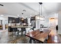 Spacious kitchen featuring a center island with a breakfast bar, modern appliances and stylish lighting at 7844 W Molly Dr, Peoria, AZ 85383