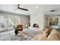 Spacious living room featuring a brick fireplace, and access to outdoor patio at 7905 E Plaza Ave, Scottsdale, AZ 85250