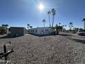 Single-story home featuring desert landscaping, shed, and a sunny view at 9068 E Chambers St, Mesa, AZ 85208