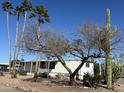 Charming single-story home with mature trees and desert landscaping at 9068 E Chambers St, Mesa, AZ 85208