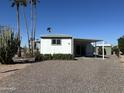 Single-story home with covered parking, desert landscaping, and private back patio at 9068 E Chambers St, Mesa, AZ 85208