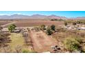 Expansive rural property showcasing a large dirt lot with beautiful mountain views in the background at 11124 W Southern Ave, Tolleson, AZ 85353