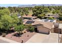 Aerial view of a home with solar panels with mountain views in the background at 12809 N 50Th St, Scottsdale, AZ 85254