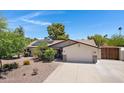 Home featuring solar panels, desert landscaping, and a two-car garage at 12809 N 50Th St, Scottsdale, AZ 85254