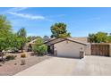 View of the house from the street showcasing desert landscaping and a wide driveway at 12809 N 50Th St, Scottsdale, AZ 85254