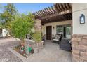 Inviting covered front porch with stone pillars, pavers, and comfortable seating for relaxing outdoors at 12809 N 50Th St, Scottsdale, AZ 85254