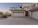 Attached two-car garage with lighting and a concrete driveway, with mountain views at 14850 E Grandview Dr # 239, Fountain Hills, AZ 85268