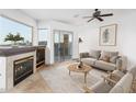 Bright living room featuring a modern fireplace and sliding doors to a private balcony at 14850 E Grandview Dr # 239, Fountain Hills, AZ 85268