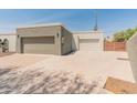 Three-car garage provides ample parking and storage space with a large driveway and clean design at 15602 N 56Th Pl, Scottsdale, AZ 85254