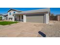 Well-maintained driveway leading to an attached two-car garage, surrounded by desert landscaping at 1658 W Pampa Ave, Mesa, AZ 85202