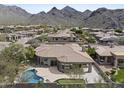 A beautiful house with a curved wall of windows, a pool, and a putting green at 16706 N 109Th Way, Scottsdale, AZ 85255