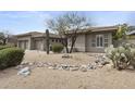 A home with a three car garage, with landscaping featuring native plants and a rock feature at 16706 N 109Th Way, Scottsdale, AZ 85255