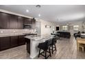 Open kitchen with a granite island flowing into the living room, great for entertaining Gathering and friends at 17308 W Daley Ln, Surprise, AZ 85387