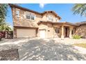 Two-story home with a large driveway and two-car garage at 18544 E Caledonia Dr, Queen Creek, AZ 85142