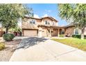 Two-story home with a spacious driveway and desert landscaping at 18544 E Caledonia Dr, Queen Creek, AZ 85142