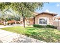 Two-story home with a well-manicured lawn and mature trees at 18544 E Caledonia Dr, Queen Creek, AZ 85142