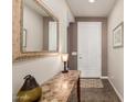 Hallway with a decorative table, mirror, and neutral-toned walls at 208 W Lantern Way, San Tan Valley, AZ 85143