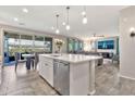 Open-concept living space featuring a kitchen island, dining area, and comfortable seating at 20846 E Longwood Dr, Queen Creek, AZ 85142