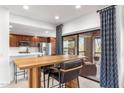 Modern kitchen featuring stainless steel appliances, sleek countertops, and a breakfast bar for casual dining at 21320 N 56Th St # 2005, Phoenix, AZ 85054