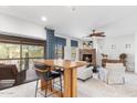 Spacious living room with a fireplace, stylish furniture, and access to an outdoor balcony with scenic views at 21320 N 56Th St # 2005, Phoenix, AZ 85054