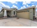 Inviting home exterior with a spacious driveway and covered porch at 265 W Rainbow Bridge Ln, San Tan Valley, AZ 85140