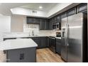 Well-equipped kitchen with stainless steel appliances, sleek countertops and an island at 280 S Evergreen Rd # 1336, Tempe, AZ 85288