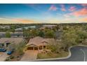 Aerial view of a home with mature trees, a lake nearby, and a three-car garage at 2876 E Cherrywood Pl, Chandler, AZ 85249