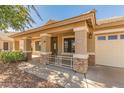 Charming front porch with stone accents and a decorative railing, offering curb appeal at 29900 N Maravilla Dr, San Tan Valley, AZ 85143