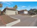 Charming home featuring a two-car garage, desert landscaping, long driveway, and well-maintained exterior at 3036 E Bluefield Ave, Phoenix, AZ 85032