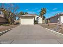 Charming home featuring a two-car garage, desert landscaping, long driveway, and well-maintained exterior at 3036 E Bluefield Ave, Phoenix, AZ 85032