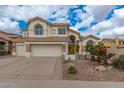 Stately home with a large driveway, three-car garage, and arched entryway at 3110 E Desert Flower Ln, Phoenix, AZ 85048