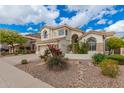 Beautiful two-story home with a well-manicured front yard and desert landscaping at 3110 E Desert Flower Ln, Phoenix, AZ 85048