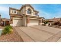 Spacious home featuring a multi-car garage and ample driveway space at 3110 E Desert Flower Ln, Phoenix, AZ 85048