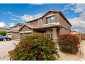 View of the house with decorative bushes with red flowers at 3126 W Apollo Rd, Phoenix, AZ 85041