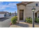 Close up of condo entrance with desert landscaping and streetlight at 3236 E Chandler Blvd # 2057, Phoenix, AZ 85048