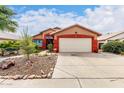 View of the two-car garage and front lawn, with beautiful desert landscaping details at 3363 W Lone Cactus Dr, Phoenix, AZ 85027